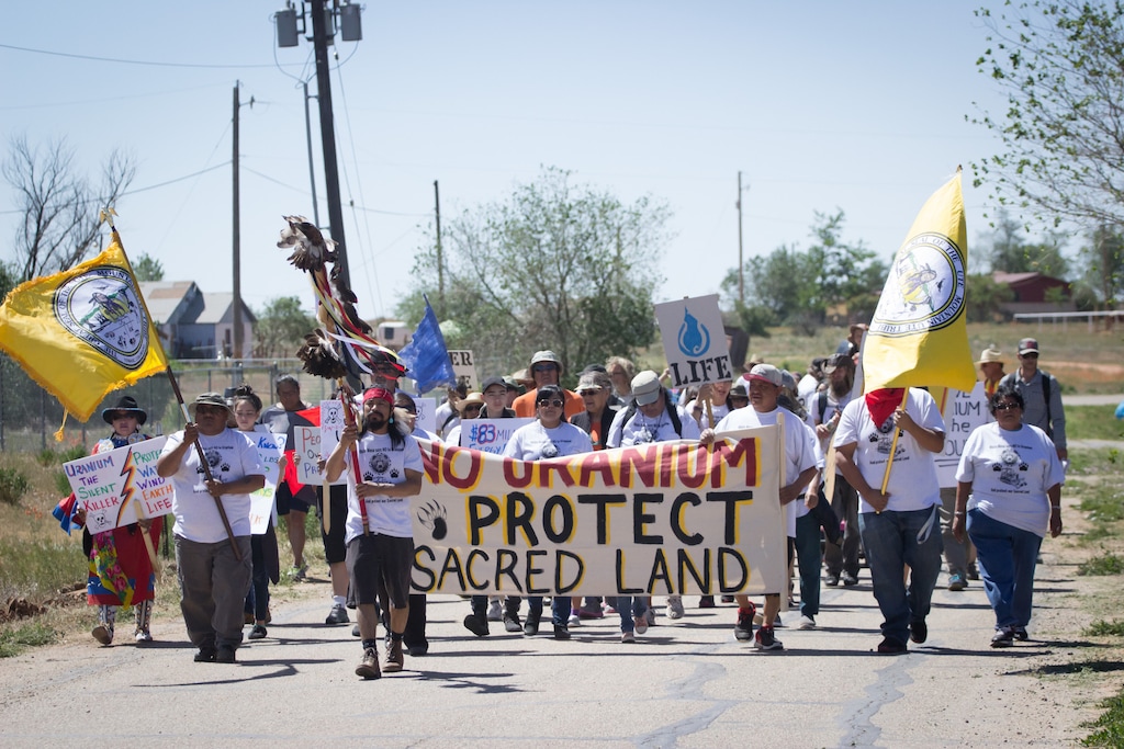 (Corey Robinson  |  Tribune file photo) Protesters from White Mesa, Utah, march against the White Mesa Mill, the last conventional uranium mill still operating in the U.S. on May 14, 2017.