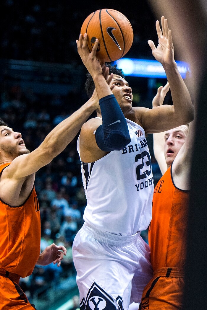 (Chris Detrick  |  The Salt Lake Tribune)  Brigham Young Cougars forward Yoeli Childs (23) shoots past Idaho State Bengals guard Geno Luzcando (1) and Idaho State Bengals forward Blake Truman (24) during the game at the Marriott Center Thursday, December 21, 2017.  