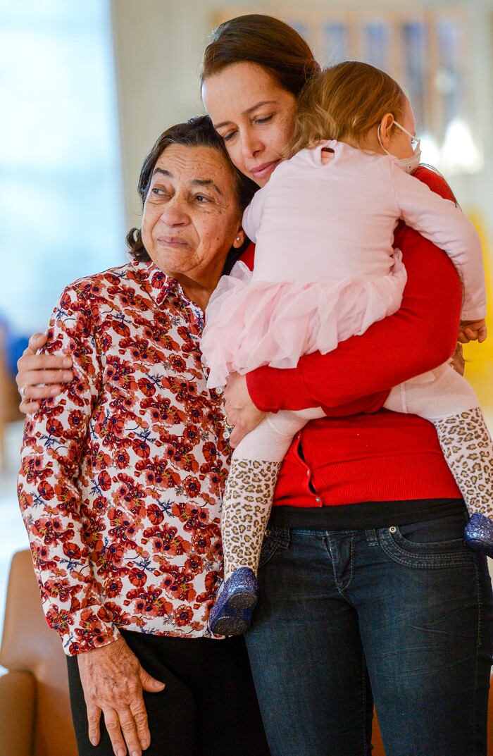 Leah Hogsten  |  The Salt Lake Tribune  l-r Lucia Silva and her daughter Flavia Beare, holding her daugher Petra, embrace in tears during a piano concert for their husband and father, Osvaldo Silva. On Friday, Intermountain Hospital caregivers wheeled paralyzed cancer patient Osvaldo Silva, 85, down to the lobby for a personal piano concert in his honor, Feb. 15, 2019. 
 With tears streaming down his face, Osvaldo, who is from Brazil, was treated to a dozen songs played by his Church of Jesus Christ of Latter-day Saints bishop, Bispo Do Pai Valdir, who kicked off the set with none other than ÒThe Girl from Ipanema.Ó  