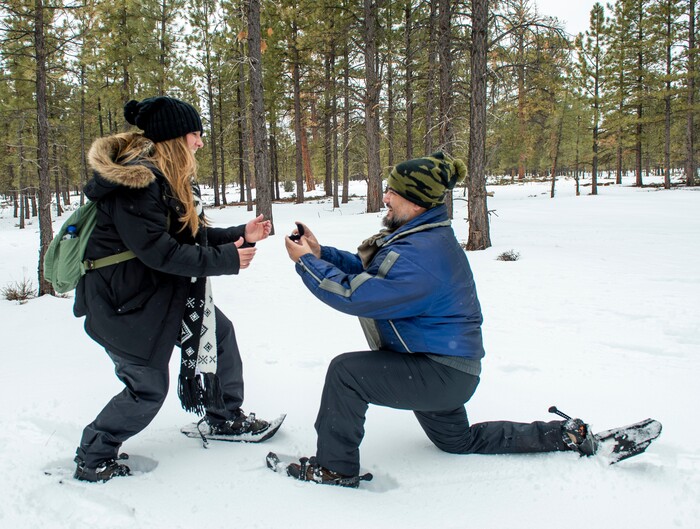 (Rick Egan | The Salt Lake Tribune) Nicole Erdmann reacts as Erik Garcia proposes to her, on a snowshoe tour of the Dixie National Forest during the 36th annual Bryce Canyon Winter Festival on Saturday, Feb. 13, 2021. Erdmann and Garcia are from Miami Florida.