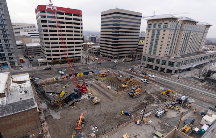 (Francisco Kjolseth | The Salt Lake Tribune) A collapsed drill rig is seen on Wednesday, March 16, 2022, at the intersection of State Street and 200 South. The rig toppled over Tuesday night at the site of the new Astra Tower, crushing two unoccupied parked cars and sending the crane operator to the hospital in serious condition.