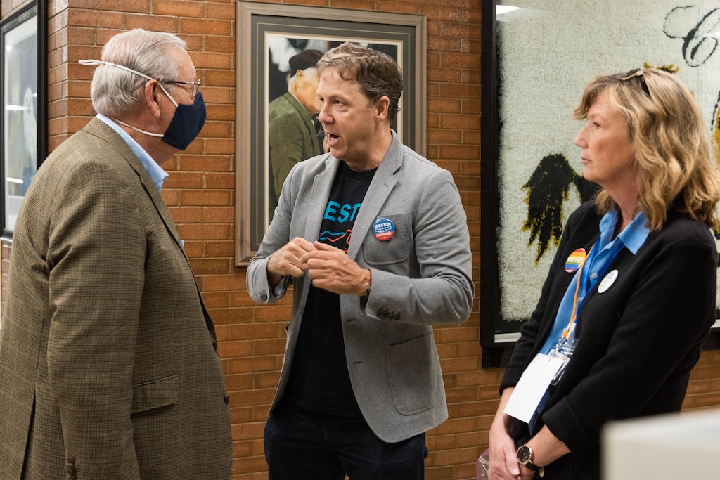 (Briana Scroggins | Special to The Tribune) Kael Weston and a Weston team volunteer, Gina Timmerman, talk with Democratic delegate Tom Lewis at Cottonwood High School in Murray, Utah on Saturday, April 23, 2022.
