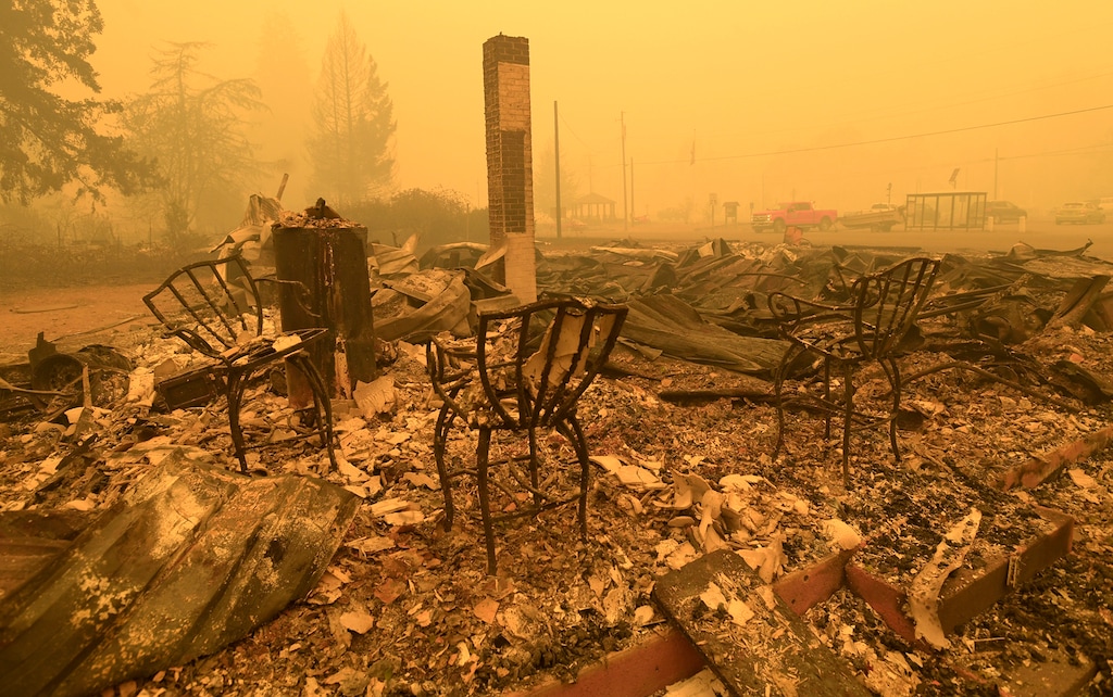 (Mark Ylen | Albany Democrat-Herald | Associated Press) Chairs stand at the Gates Post office in the aftermath of a fire in Gates, Ore., Sept 9, 2020. The post office was destroyed along with several other buildings in the Santiam Canyon community as a result of the Santiam Fire. A jury verdict that found power company PacifiCorp liable for devastating wildfires in Oregon in 2020 is highlighting the legal and financial risks utilities face if they fail to take proper precautions for climate change.