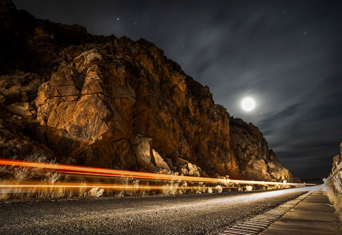 (Leah Hogsten | The Salt Lake Tribune) A car's headlights and break lights illuminate the Parowan Gap, the night before the spring equinox, Mar. 19, 2021. According to the Utah Geological Survey, the Parowan Gap, formed millions of years ago is a classic example of a wind gap, where an ancient river cut a 600-foot deep notch through the Navajo Sandstone of the Red Hills. The Gap is believed to have the most concentrated collections of petroglyphs in the West, dating back some 5,000 years with over 90 panels featuring some 1,500 figures.