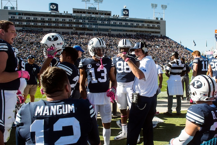 (Chris Detrick  |  The Salt Lake Tribune)  Offensive Coordinator and Quarterbacks Coach Ty Detmer talks with Brigham Young Cougars quarterback Tanner Mangum (12) during the game at LaVell Edwards Stadium Saturday, October 28, 2017.  