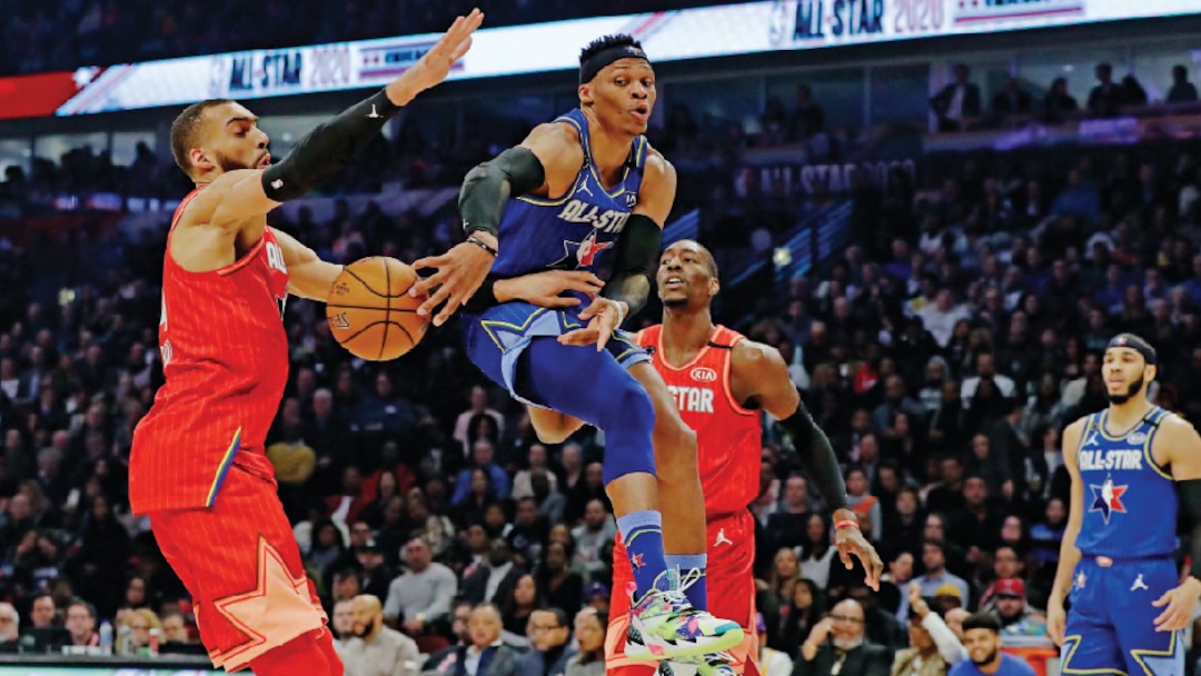 Russell Westbrook of the Houston Rockets passes around Utah Jazz center Rudy Gobert during the first half of the NBA All-Star basketball game Sunday, Feb. 16, 2020, in Chicago. (AP Photo/Nam Huh)