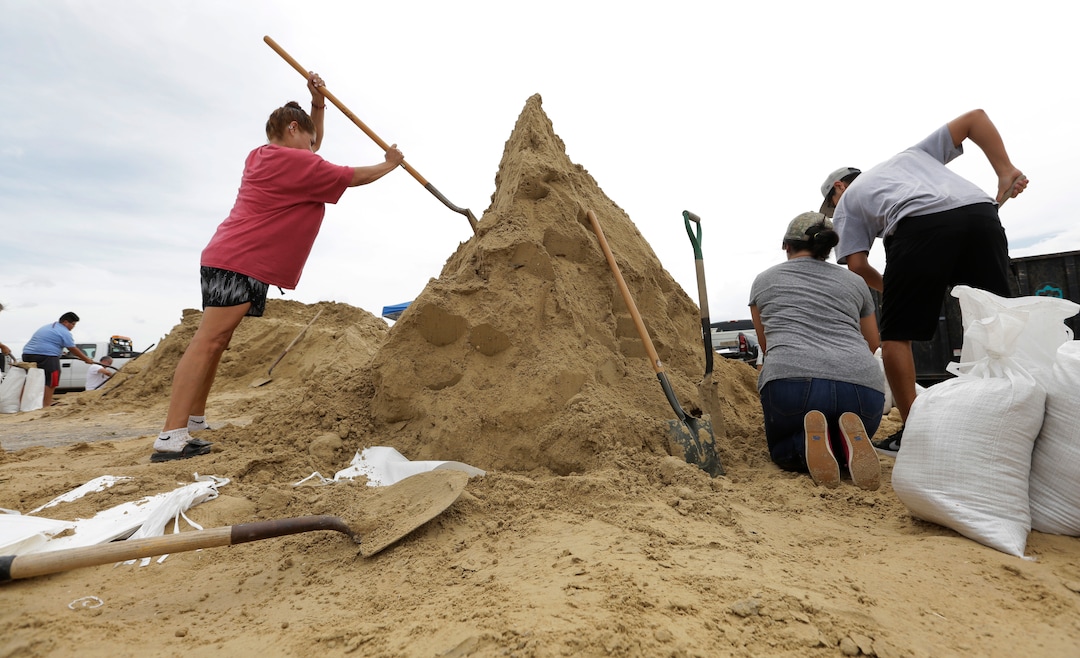 (Eric Gay | The Associated Press)  Residents fill sand bags as they prepare for Hurricane Harvey, Thursday, Aug. 24, 2017, in Corpus Christi, Texas.  Two counties have ordered mandatory evacuations as Hurricane Harvey gathers strength as it drifts toward the Texas Gulf Coast.