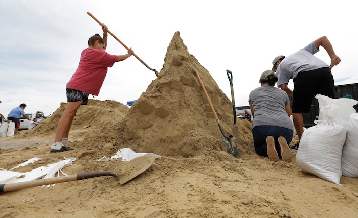 (Eric Gay | The Associated Press)  Residents fill sand bags as they prepare for Hurricane Harvey, Thursday, Aug. 24, 2017, in Corpus Christi, Texas.  Two counties have ordered mandatory evacuations as Hurricane Harvey gathers strength as it drifts toward the Texas Gulf Coast.