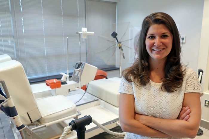 (Felicia Fonseca | AP) In this June 25, 2019 photo. Lauren Edgar, a research geologist for the U.S. Geological Survey's Astrogeology Science Center in Flagstaff, Ariz., poses in front of a prototype of a lunar rover that was used to train astronauts in northern Arizona.