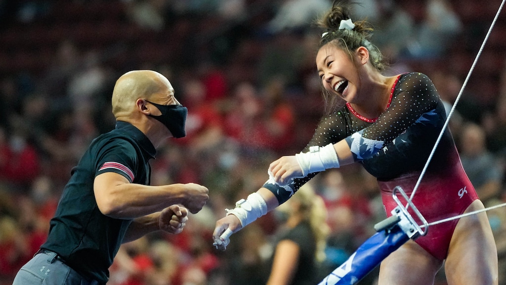 (Francisco Kjolseth | The Salt Lake Tribune) Utah coach Tom Farden celebrates with Cristal Isa following her performance on the parallel bars at the Best of Utah NCAA Gymnastics Meet at the Maverik Center in West Valley City on Friday, Jan. 7, 2022. The Utes won their regional meet Saturday to advance to the finals.