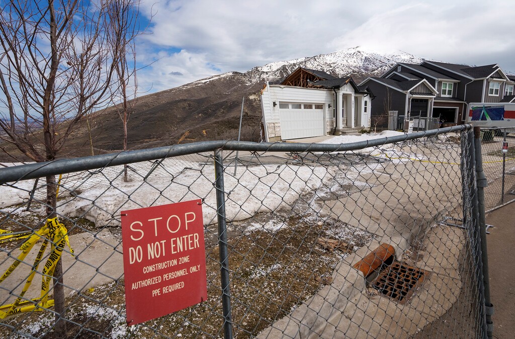 (Leah Hogsten | The Salt Lake Tribune) The scene on Monday, April 24, 2023, where two homes located at 2463 and 2477 E. Springtime Road collapsed into a canyon on Saturday. The homes were evacuated in October after Draper building officials revoked the certificates of occupancy for the residences. The city declared both homes in Hidden Canyon Estates “unfit for human habitation” due to dangerous conditions in soil shifting and breaks in the homes’ foundations.