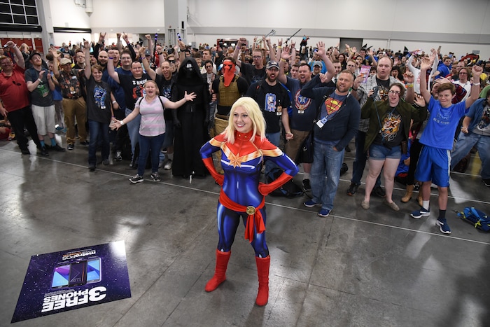 (Francisco Kjolseth  |  The Salt Lake Tribune)  Kaylynn Wolfe of Layton as Captain Marvel poses for a photo with attendees to the start of FanX Salt Lake Comic Convention at the Salt Palace in Salt Lake City Thursday, Sept. 6, 2018, during the three-day pop culture convention.