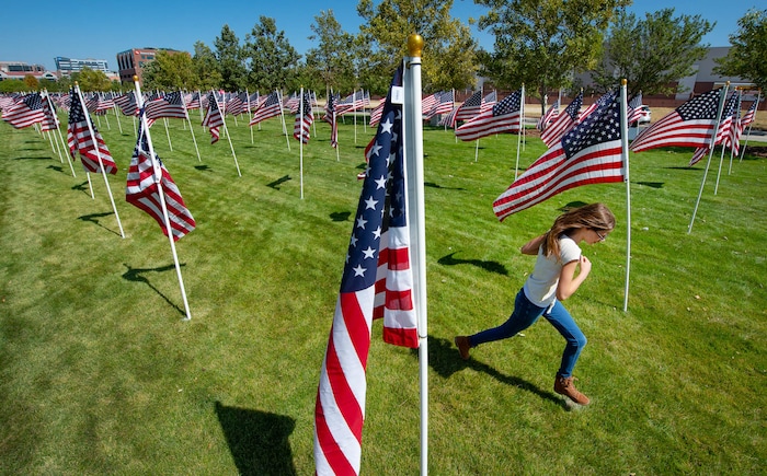 (Francisco Kjolseth | The Salt Lake Tribune) The Utah Healing Field marks the 19th anniversary of the 9/11 attacks, as as people visit the 1500 flags on the promenade outside Sandy City Hall on Friday, Sept. 11, 2020. This year the flags are spaced out more than they have in the past to allow for social distancing among people who visit the display.