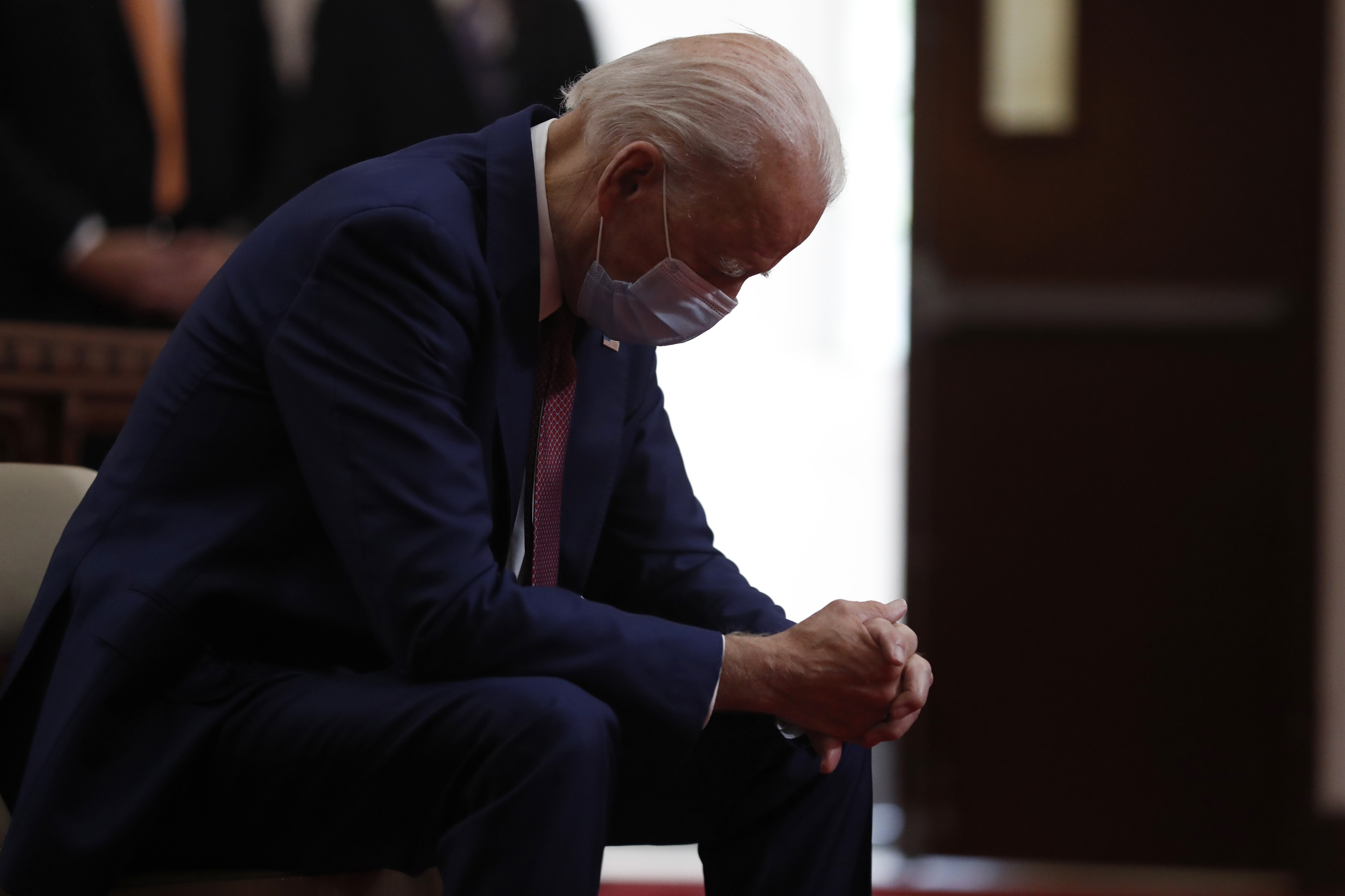 (AP Photo/Andrew Harnik, File) In this  June 1, 2020, file photo, Democratic presidential candidate, former Vice President Joe Biden bows his head in prayer as he visits Bethel AME Church in Wilmington, Del.