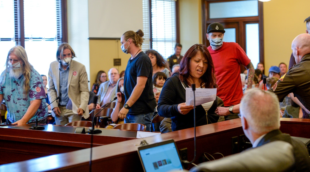 (Leah Hogsten  |  The Salt Lake Tribune) Maura Sanchez, right, and other opponents of the proposed inland port voice their opposition at the Utah Inland Port Authority Board meeting by Utah Highway Patrol officers at the Capitol, June 5, 2019. The Inland Port Authority Board had to cancel its meeting last month after a group of protesters took over the meeting. Petersen was arrested.