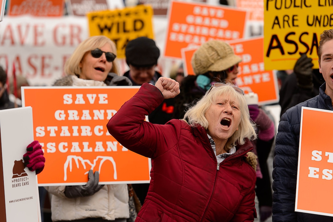 (Trent Nelson | The Salt Lake Tribune)  Tami Sablan and other protesters chant before a visit by President Donald Trump, Monday December 4, 2017.
