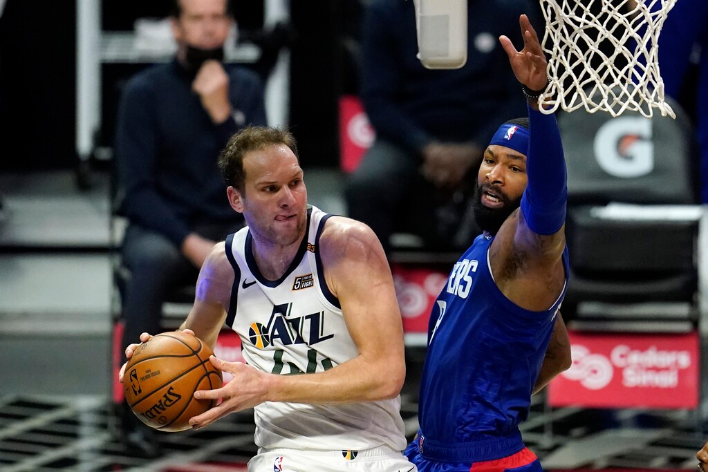 Utah Jazz forward Bojan Bogdanovic, left, looks to pass under the basket as Los Angeles Clippers forward Marcus Morris Sr. defends during the first half of an NBA basketball game Wednesday, Feb. 17, 2021, in Los Angeles. (AP Photo/Marcio Jose Sanchez)
