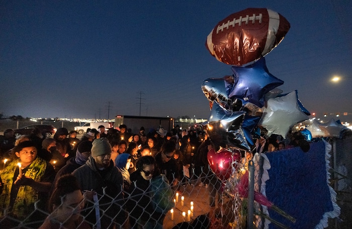 (Francisco Kjolseth | The Salt Lake Tribune) More that a hundred people gather at the candlelight vigil of Hunter High football players Paul Tahi , 15, Tivani Lopati, 14, and Ephraim Asiata, 15, on Friday, Jan 14, 2022, in West Valley City, near Hunter High School along 1400 South at Mountain View Corridor. Paul Tahi and Tivani Lopati were killed in a shooting, while Ephraim Asiata remains in critical condition.