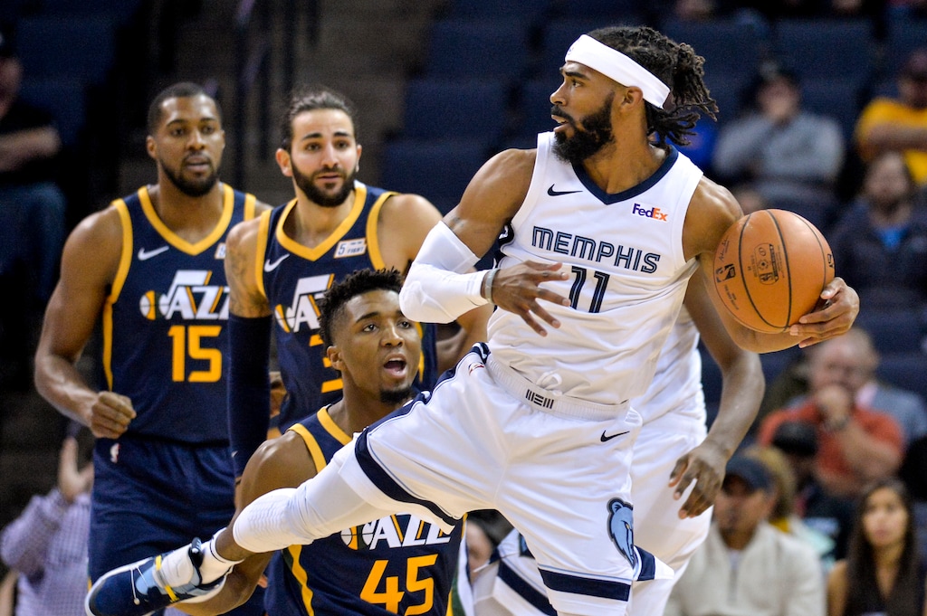 Memphis Grizzlies guard Mike Conley (11) controls the ball against Utah Jazz guard Donovan Mitchell (45) in the first half of an NBA basketball game Monday, Nov. 12, 2018, in Memphis, Tenn. (AP Photo/Brandon Dill)