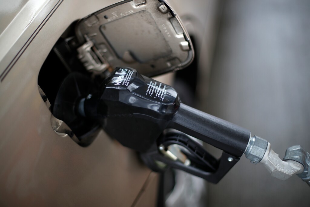 FILE - In this Nov. 16, 2018, file photo, a gas pump nozzle fills up gas in a car at a pump in West Mifflin, Pa. Expect prices to be relatively stable compared to this year, says Tom Kloza global head of energy analysis for the Oil Price Information Service. He said there is a good chance that 2019 will be book-ended by a very weak start for prices and a shaky finish _ with prices around $2.35 to $2.40 a gallon at each end. In between, prices will advance for both crude oil and gasoline.(AP Photo/Gene J. Puskar, File)