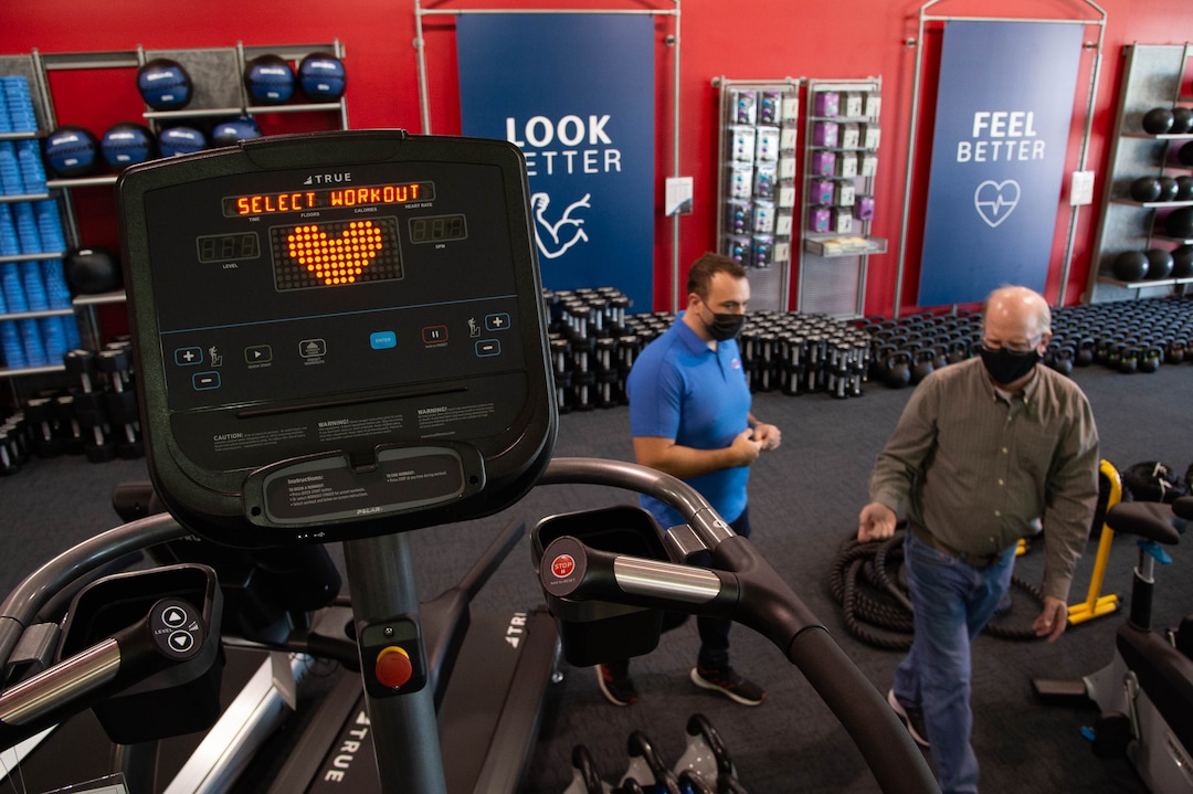 (Francisco Kjolseth  |  The Salt Lake Tribune) Clint Eisinger, operations manager at Utah Home Fitness in Sandy, helps a customer on Wednesday, Oct. 22, 2020. Home fitness equipment sales boomed in March and April when gyms closed because of the coronavirus. Everything from inexpensive dumbbells to premium treadmills and ellipticals were wiped out of stores and warehouses. Record sales continue throughout the summer — normally the slow time for the industry, and store owners expect sales to remain high during the holidays.