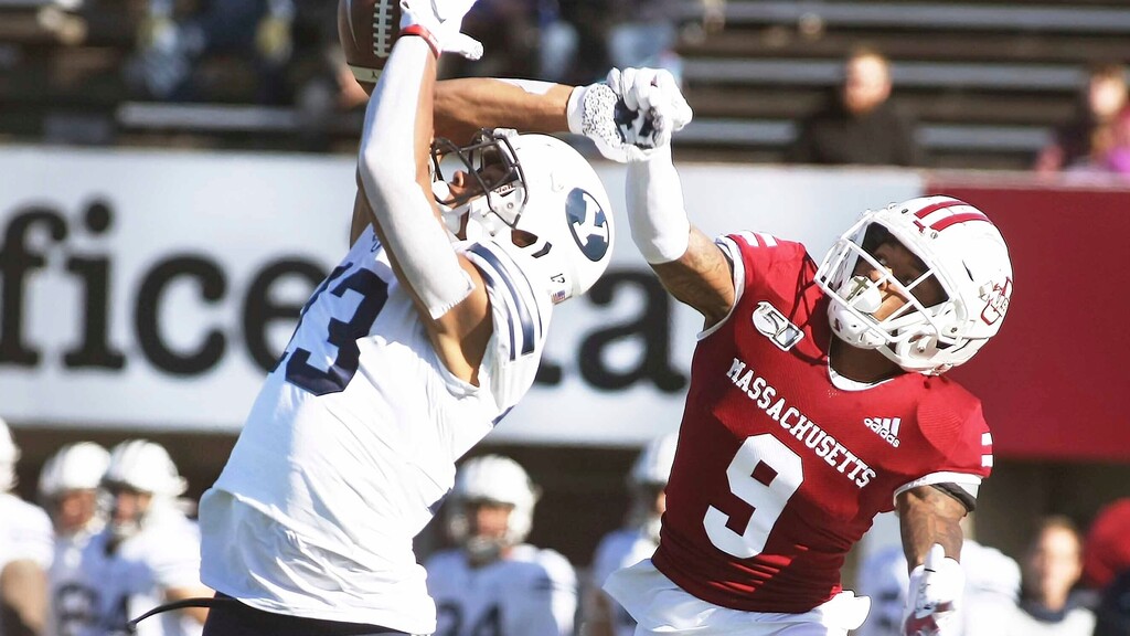(J. Anthony Roberts | The Republican via AP) Massachusetts Isaiah Rodgers, right, leaps up and knocks the ball out of the hands of BYU wide receiver Micah Simon during an NCAA college football game, Saturday, Nov. 23, 2019 in Amherst, Mass.