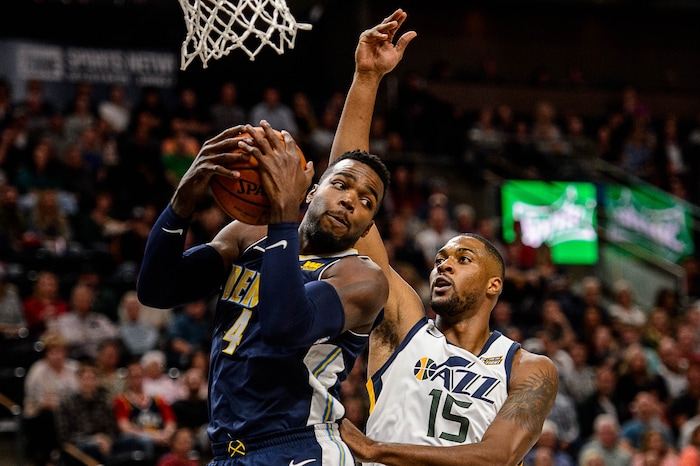 (Trent Nelson | The Salt Lake Tribune)  Denver Nuggets forward Paul Millsap (4) pulls down a rebound ahead of Utah Jazz forward Derrick Favors (15) as the Utah Jazz host the Denver Nuggets, NBA basketball in Salt Lake City, Wednesday October 18, 2017.