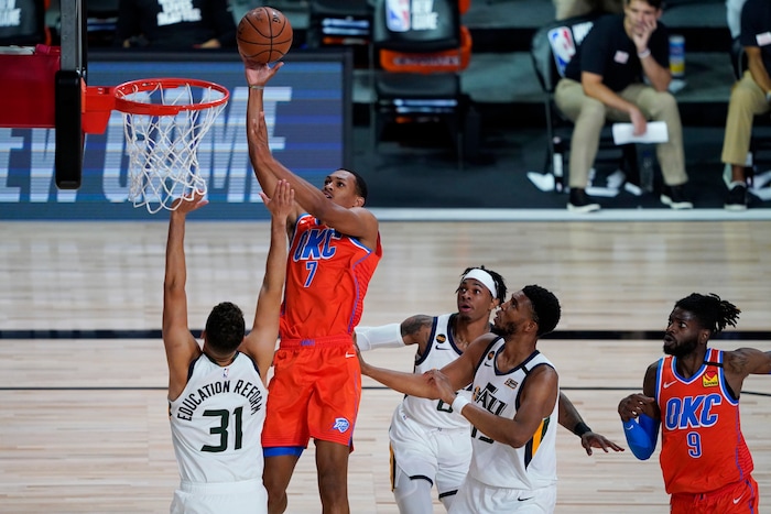 Oklahoma City Thunder's Darius Bazley (7) shoots over Utah Jazz's Georges Niang (31) during the second half of an NBA basketball game Saturday, Aug. 1, 2020, in Lake Buena Vista, Fla. (AP Photo/Ashley Landis, Pool)