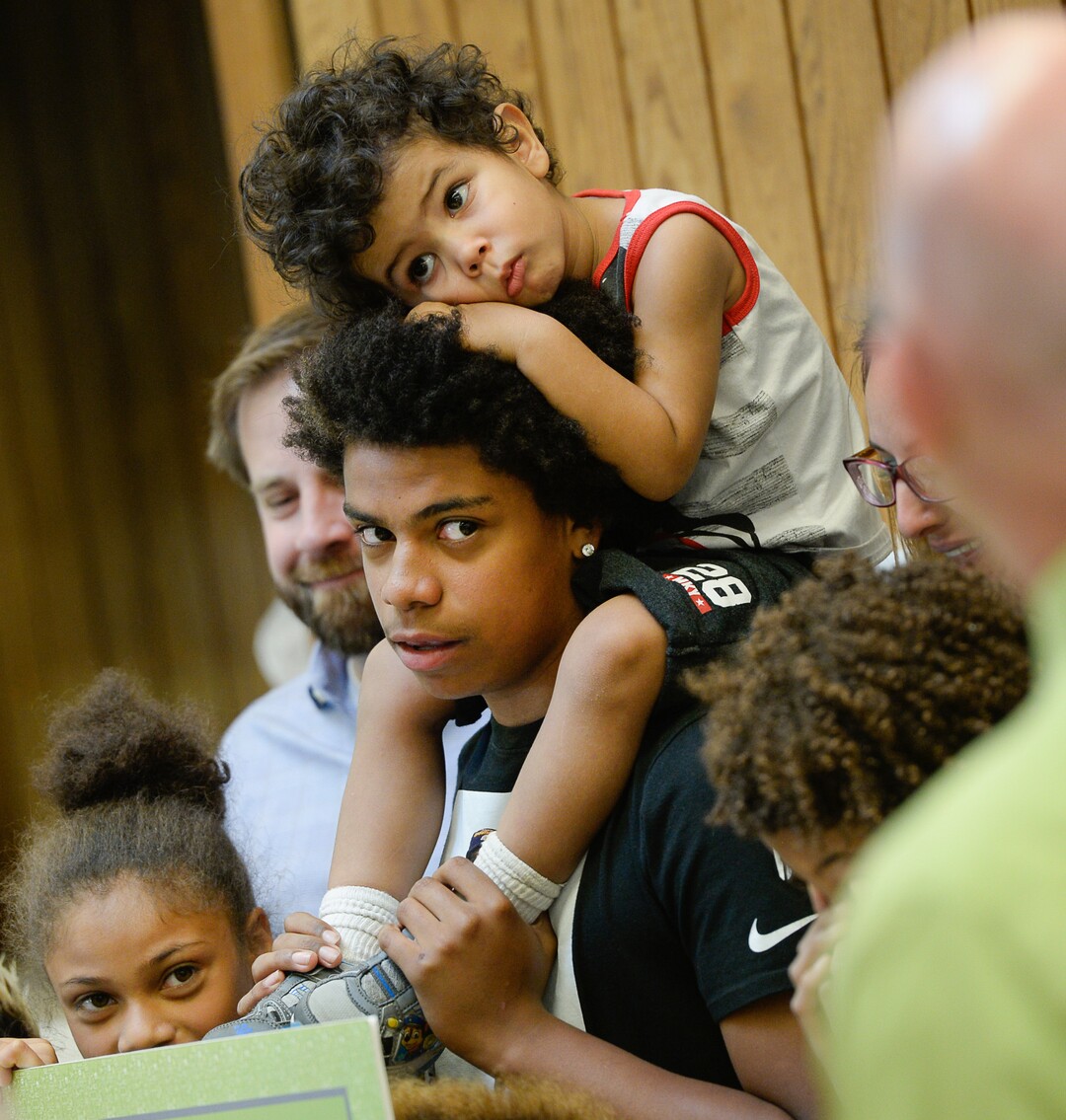 (Francisco Kjolseth  |  The Salt Lake Tribune)  Kearns High sophomore Keeven Wilson, 16, with brother Kinston, 3, on top, gathers for family photos after being announced as Granite School District's Absolutely Incredible Kid award winner during the school farewell assembly on Tuesday, May 22, 2018. Wilson who had a particularly difficult home life, to the point that he and his siblings were taken away from his parents and near universal F's during his junior high days turned his life around.  With the help of a new foster family, teachers and his football coach, he is now an honor roll student and thinking of studying psychology in college.