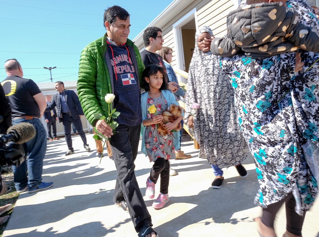(Francisco Kjolseth  |  The Salt Lake Tribune)  Muhahed Shaikh is joined by his daughter Maryam, 8, as they receive flowers from the community following Friday prayers services at the Al Sahaba Mosque in Orem in a show of love and support following the tragic shootings in New Zealand. 