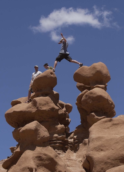 (Trent Nelson | The Salt Lake Tribune) Sight-seer leaps from one "goblin" to another on a warm Memorial Day in Goblin Valley State Park