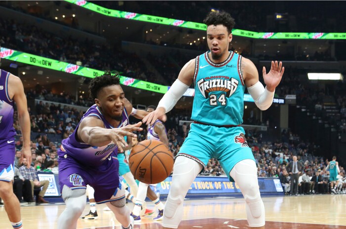 Utah Jazz guard Donovan Mitchell (45) goes for a loose ball as Memphis Grizzlies guard Dillon Brooks (24) in the first half of an NBA basketball game Friday, Nov. 29, 2019, in Memphis, Tenn. (AP Photo/Karen Pulfer Focht)