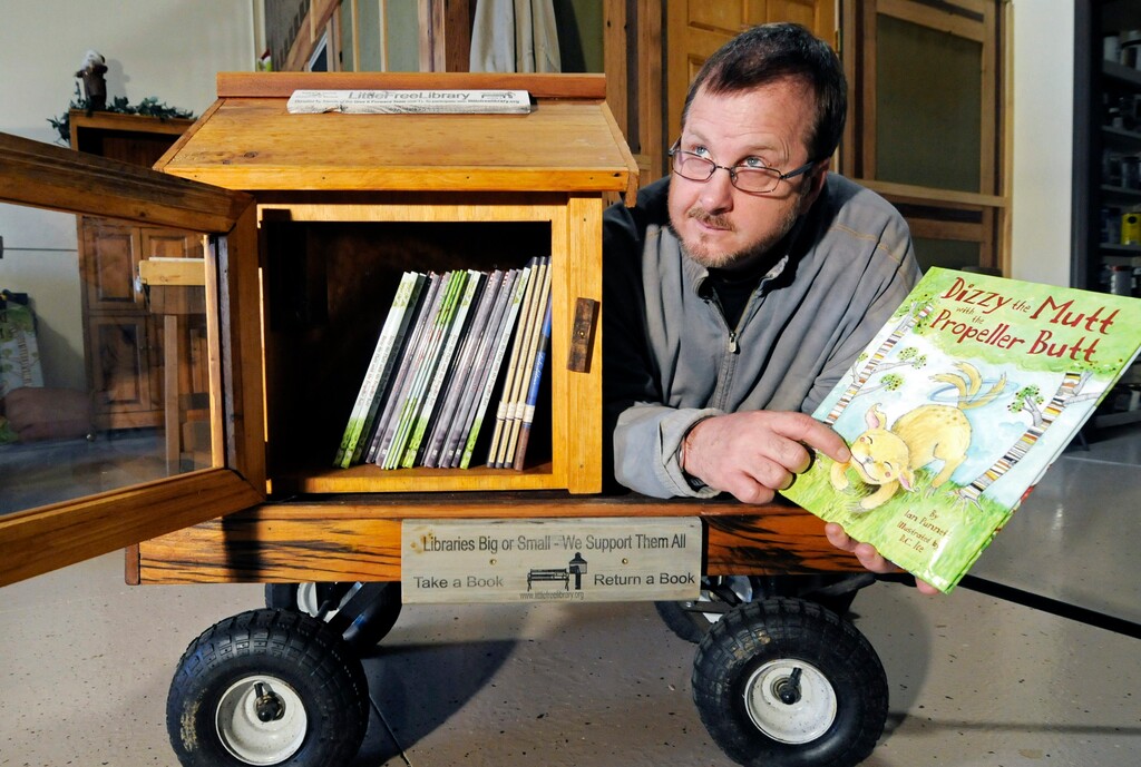 (Jim Mone | The Associated Press) In this Dec. 6, 2012 file photo, Todd Bol poses with a Little Free Library lending boxes in Hudson, Wis. Bol, who founded Little Free Library, the boxes of books for sharing that popped up across the U.S. and spread to more than 80 countries, died Thursday, Oct. 18, 2018, in a Minnesota hospice of complications from pancreatic cancer, according to Little Free Library spokeswoman Margret Aldrich. He was 62.