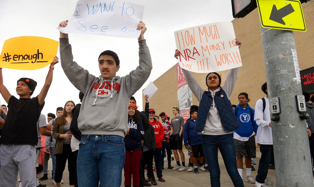 (Leah Hogsten  |  The Salt Lake Tribune) East High School students took to the corner of 13th East and 800 South to raise awareness and push for change. Exactly one month after 17 people were killed at Marjory Stoneman Douglas High School in Parkland, survivors of the massacre joined tens of thousands of students across the United States by walking out of school,  Wednesday, March 14, 2018. 