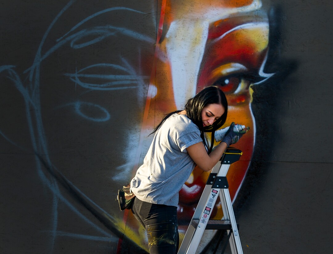 (Leah Hogsten | The Salt Lake Tribune)  Muralist Harriet Wood from Bristol, England, who goes by the name of "@HazardOne" paints at the 2nd annual Mural Fest sponsored by South Salt Lake Arts Council and Utah Arts Alliance. Ten murals were created in South Salt Lake's community between 2100 and 2400 South off of West Temple, May 11, 2019.