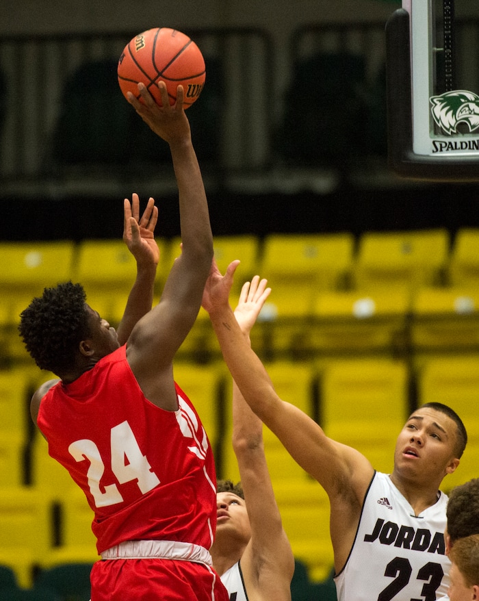 (Rick Egan  |  The Salt Lake Tribune)  East Leopards Andre Mulibea (24) shoots over Jordan Beatdiggers Dyson Frank (23), in 5A basketball playoff action between the East Leopards and the Jordan Beatdiggers at the UCCU Center in Orem, Monday, Feb. 26, 2018.