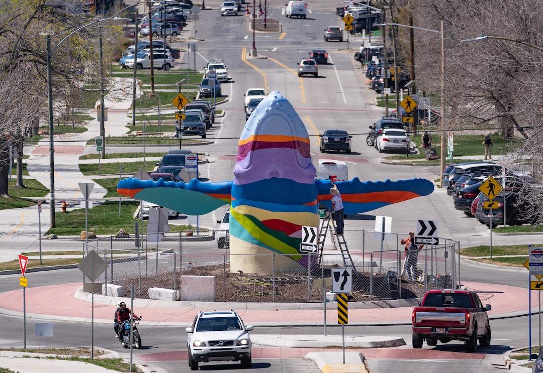(Francisco Kjolseth | The Salt Lake Tribune) The large breaching humpback whale sculpture at the intersection of 900 South 1100 East gets its inaugural paint scheme inspired by the view of the Salt Lake valley on Friday, April 8, 2022. A new artist is expected to change the paint design every few years. 