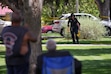 (Chris Samuels | The Salt Lake Tribune) Onlookers watch as police investigate a shooting that occurred outside a meetinghouse of The Church of Jesus Christ of Latter-day Saints in Kearns, Monday, Aug. 17, 2026.