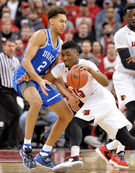 Louisville's Donovan Mitchell (45) attempts to get past the defense of Duke's Chase Jeter (2) during the first half of an NCAA college basketball game, Saturday, Jan. 14, 2017, in Louisville, Ky. (AP Photo/Timothy D. Easley)