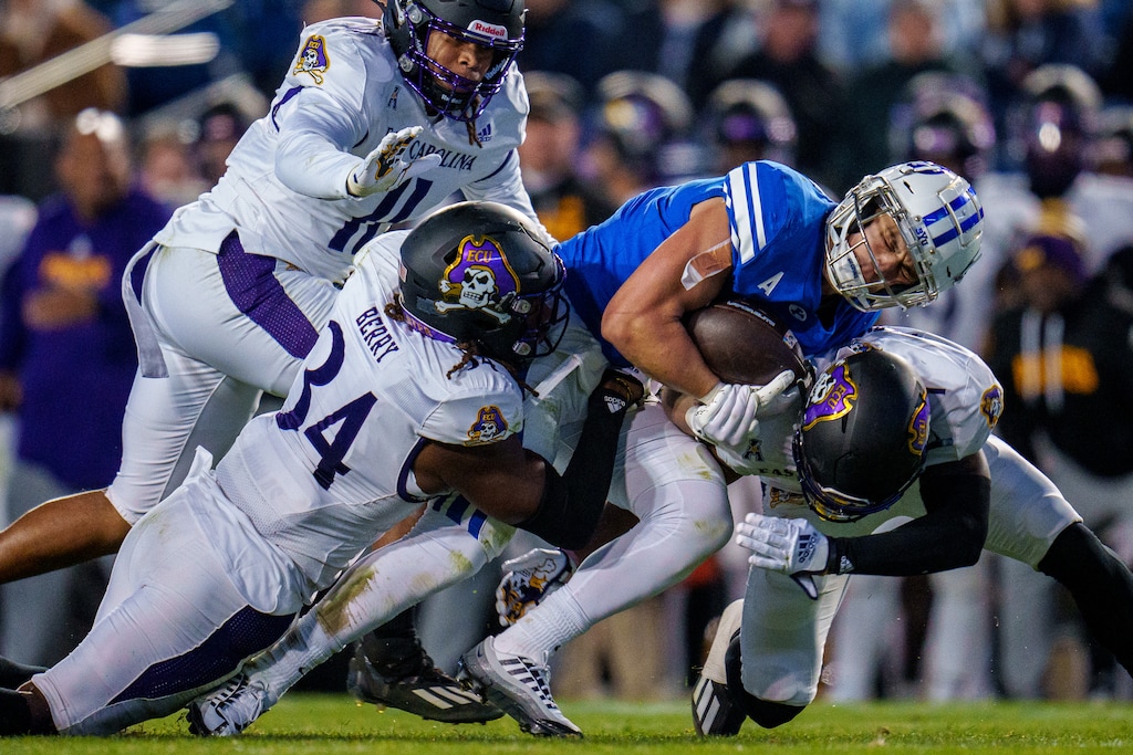 (Trent Nelson  |  The Salt Lake Tribune) Brigham Young Cougars running back Lopini Katoa (4) is tackled as BYU hosts East Carolina, NCAA football in Provo on Friday, Oct. 28, 2022.