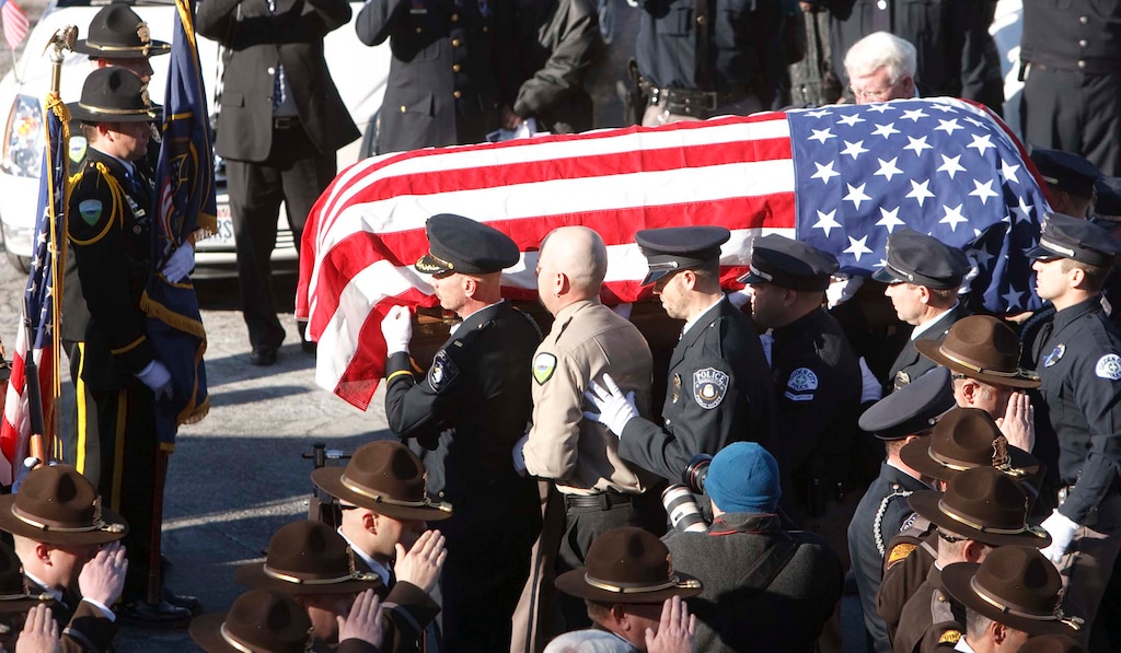 Leah Hogsten | The Salt Lake Tribune  

Members of the Ogden Police Department carry the casket of Ogden police Officer Jared Francom, Wednesday, January 11, 2012.