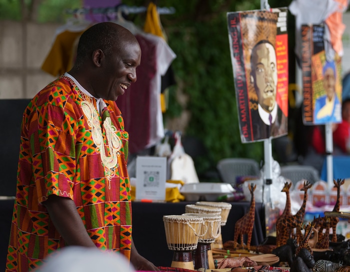 (Leah Hogsten | The Salt Lake Tribune) David Ssejinja sells goods made by women and children from Uganda to benefit them through his Ssejinja Children's Foundation at the Utah Juneteenth Celebration at the Ogden City Amphitheater, Saturday, June 18, 2022. 