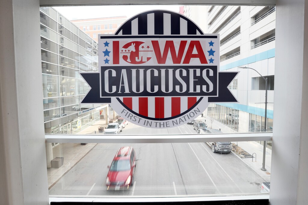 A sign for the Iowa Caucuses is seen in the window on a downtown skywalk, Tuesday, Feb. 4, 2020, in Des Moines, Iowa. (AP Photo/Charlie Neibergall)
