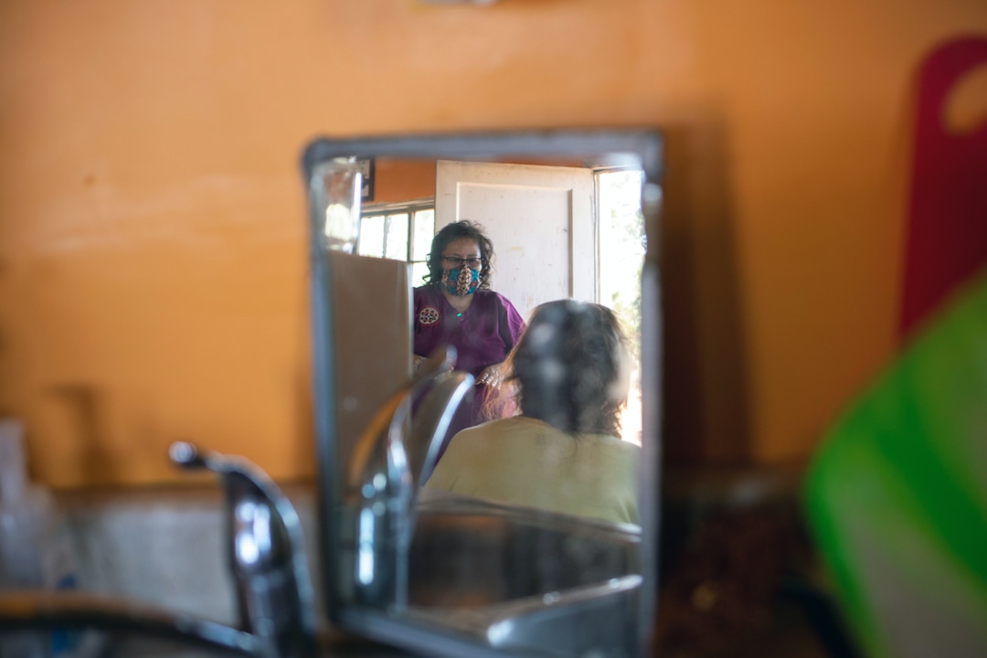 (Sharon Chischilly | The New York Times) Philana Brown, a public health nurse, delivers food and supplies to a patient in Kayenta, Ariz., on Aug. 31, 2020. Brown tested positive for the coronavirus herself.