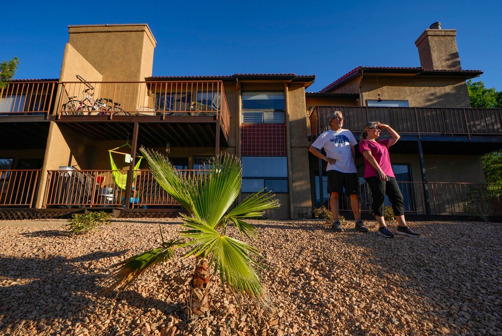 (Francisco Kjolseth  |  The Salt Lake Tribune) Aubrey Quick, the treasurer for the Gardens South Condominiums homeowners association in St. George, is joined by her husband Dale Hawkins, as they tour a project to remove grass in common areas in their community on Tuesday, June 11, 2024. Thus far, the condominium complex has replaced 5,000 square feet of grass. 