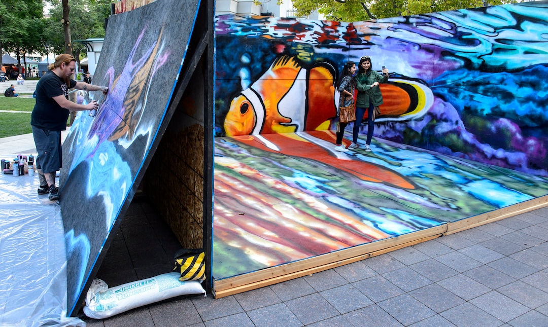 (Steve Griffin  |  The Salt Lake Tribune) People take photos in a giant mural during the Urban Arts Festival at the Gallivan Center in Salt Lake City Sunday September 17, 2017. The two day festival featured artists, music, dance performance, automotive arts, projection art, virtual reality and new media arts.