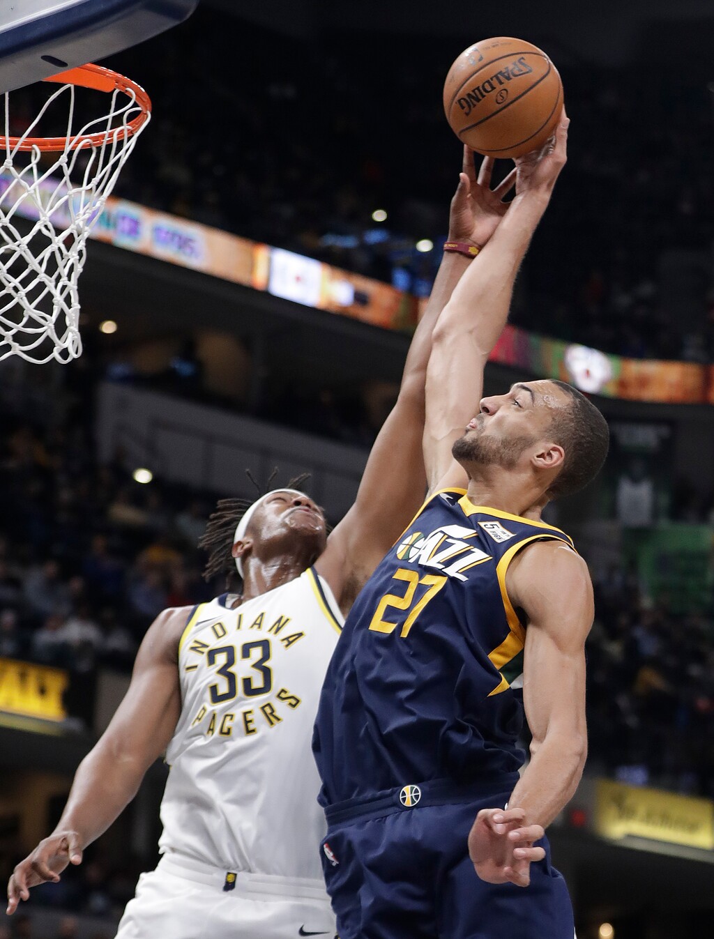 Indiana Pacers' Myles Turner and Utah Jazz's Rudy Gobert reach for a rebound during the second half of an NBA basketball game Wednesday, March 7, 2018, in Indianapolis. Utah won 104-84. (AP Photo/Darron Cummings)