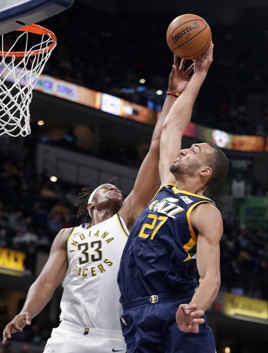 Indiana Pacers' Myles Turner and Utah Jazz's Rudy Gobert reach for a rebound during the second half of an NBA basketball game Wednesday, March 7, 2018, in Indianapolis. Utah won 104-84. (AP Photo/Darron Cummings)