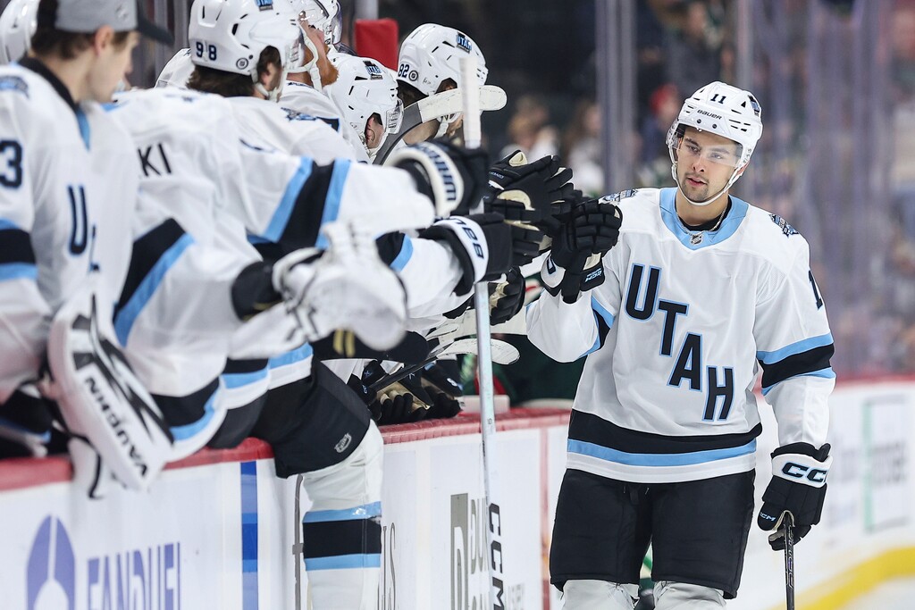 Utah Hockey Club right wing Dylan Guenther (11) is congratulated for his goal against the Minnesota Wild during the first period of an NHL hockey game Friday, Dec. 20, 2024, in St. Paul, Minn. (AP Photo/Matt Krohn)