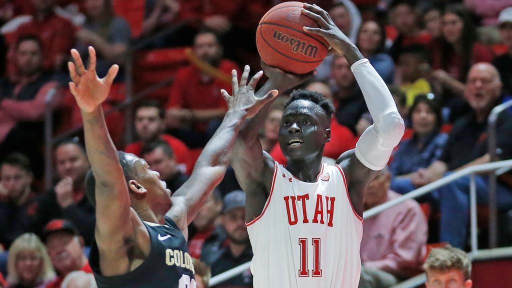 Utah guard Both Gach (11) shoots as Colorado guard McKinley Wright IV (25) defends in the second half during an NCAA college basketball game Saturday, March 7, 2020, in Salt Lake City. (AP Photo/Rick Bowmer)